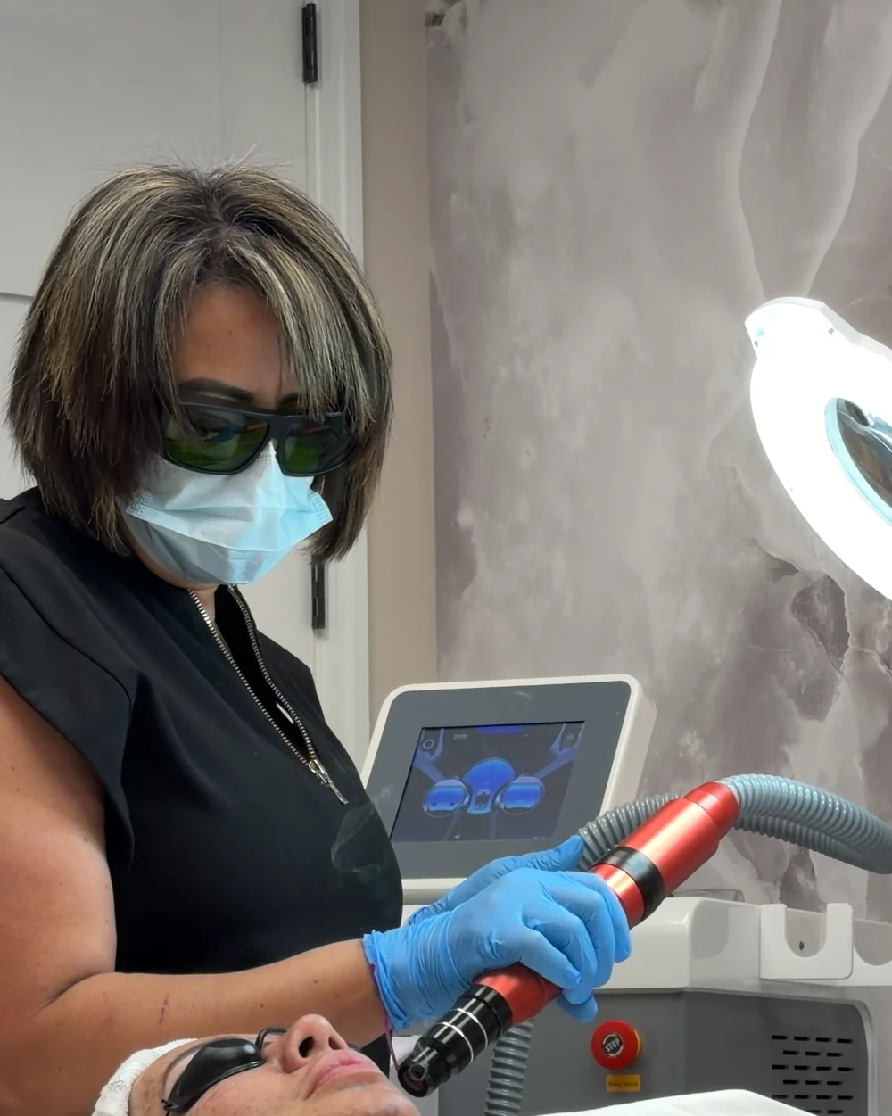 Karina working with a laser device